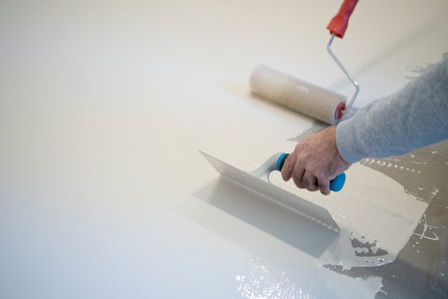 Worker works with polyurethane resin for interiors